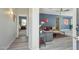 Open-concept living space with grey walls, wood floors, and access to a bedroom and kitchen at 897 E Cherry Hills Dr, Chandler, AZ 85249