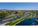 Beautiful community pond with landscaping, a white fence, and palm trees in a residential neighborhood at 897 E Cherry Hills Dr, Chandler, AZ 85249