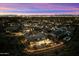 Twilight aerial view showcasing the property surrounded by city lights and desert landscape at 9539 S 13Th Way, Phoenix, AZ 85042