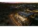 Night aerial view highlighting the home's backyard entertainment area with a dining setup at 9539 S 13Th Way, Phoenix, AZ 85042