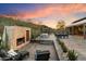 Beautiful backyard with an outdoor fireplace, desert landscaping, and lounge chairs at 9539 S 13Th Way, Phoenix, AZ 85042