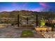 Landscaped backyard with desert plants, hammock, and scenic desert views at dusk at 9539 S 13Th Way, Phoenix, AZ 85042