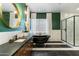 A modern bathroom with a sleek black clawfoot tub, elegant finishes, and a walk-in shower at 9539 S 13Th Way, Phoenix, AZ 85042