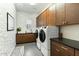 Well-appointed laundry room with modern appliances, custom cabinetry and stylish decor at 9539 S 13Th Way, Phoenix, AZ 85042
