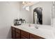 A well-lit bathroom featuring a spacious counter, mirror and sink at 1350 S Greenfield Rd # 1225, Mesa, AZ 85206