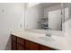 A well-lit bathroom featuring a spacious counter, mirror, sink, and -themed shower curtain at 1350 S Greenfield Rd # 1225, Mesa, AZ 85206