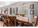 Cozy dining area featuring a wooden table, stylish decor, and natural light from the windows at 1350 S Greenfield Rd # 1225, Mesa, AZ 85206