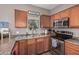 Cozy kitchen with wooden cabinets, modern appliances, and ample countertop space for meal preparation at 1350 S Greenfield Rd # 1225, Mesa, AZ 85206