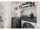 Efficient laundry area featuring stacked washer and dryer, plus practical storage shelving at 1350 S Greenfield Rd # 1225, Mesa, AZ 85206