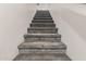 A carpeted staircase leads upwards, offering a transition between the home's levels at 1350 S Greenfield Rd # 1225, Mesa, AZ 85206