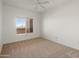 Sunlit bedroom featuring neutral carpet and a window offering serene views at 14000 N 94Th St # 3094, Scottsdale, AZ 85260