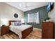 Well lit bedroom showing wooden furniture, a ceiling fan and large window at 14442 W Lexington Ave, Goodyear, AZ 85395