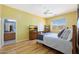 Bedroom with hardwood floors, ceiling fan, and a tv on top of a dresser at 14442 W Lexington Ave, Goodyear, AZ 85395