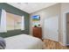 Cozy bedroom featuring a ceiling fan, window, wood dresser, and closet with white doors at 14442 W Lexington Ave, Goodyear, AZ 85395