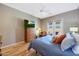 Cozy bedroom featuring wooden floors, ceiling fan, and a TV for entertainment at 14442 W Lexington Ave, Goodyear, AZ 85395