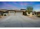 Attractive home with a three-car garage, tile roof, and desert landscaping offers a welcoming entrance at 14442 W Lexington Ave, Goodyear, AZ 85395