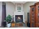 Close-up of the fireplace featuring stone surround, mantle decor, and a cozy ambiance at 14442 W Lexington Ave, Goodyear, AZ 85395