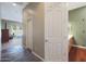 Hallway view leading into a bedroom with a sliding glass door and into a bathroom with a double sink vanity at 14442 W Lexington Ave, Goodyear, AZ 85395