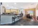 Kitchen featuring wood cabinets, bar seating, and an adjacent dining area, creating an inviting space at 14442 W Lexington Ave, Goodyear, AZ 85395