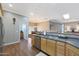 Well-lit kitchen showcasing stainless steel appliances and breakfast bar that opens to the dining area, perfect for entertaining at 14442 W Lexington Ave, Goodyear, AZ 85395