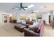 Spacious living area with skylights, ceiling fans, wood floors, and comfortable furniture at 14442 W Lexington Ave, Goodyear, AZ 85395