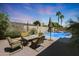 Outdoor seating area with a fire pit overlooking a pool at 14442 W Lexington Ave, Goodyear, AZ 85395