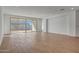 Expansive living room featuring wood-look tile and sliding glass doors at 14761 W Tether Trl, Surprise, AZ 85387