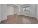 Inviting living room with wood-look tile flooring and large window at 14761 W Tether Trl, Surprise, AZ 85387