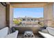 Cozy balcony with comfortable seating offers neighborhood views and clear blue skies at 16420 N Thompson Peak Pkwy # 2091, Scottsdale, AZ 85260