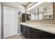 Well-lit bathroom featuring double sinks, dark wood cabinetry, and ample countertop space at 16420 N Thompson Peak Pkwy # 2091, Scottsdale, AZ 85260