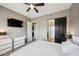 Bedroom featuring neutral tones, a ceiling fan, and access to an ensuite bathroom and walk-in closet at 16420 N Thompson Peak Pkwy # 2091, Scottsdale, AZ 85260