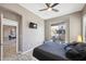 Bedroom featuring dark bedding, a ceiling fan, and a balcony with neighborhood views at 16420 N Thompson Peak Pkwy # 2091, Scottsdale, AZ 85260