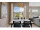 Dining room with wood table set, designer lighting, and view to balcony through sliding glass doors at 16420 N Thompson Peak Pkwy # 2091, Scottsdale, AZ 85260