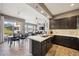 Modern kitchen featuring dark cabinetry, updated appliances, and a breakfast bar at 16420 N Thompson Peak Pkwy # 2091, Scottsdale, AZ 85260