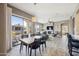 Open-concept living room and dining area featuring a stone fireplace and large windows leading to a patio at 16420 N Thompson Peak Pkwy # 2091, Scottsdale, AZ 85260