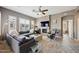 Elegant living room featuring a stone fireplace, plush seating, plantation shutters, and ample natural light at 16420 N Thompson Peak Pkwy # 2091, Scottsdale, AZ 85260