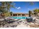 Community pool with lounge chairs and umbrellas surrounded by lush landscaping at 16420 N Thompson Peak Pkwy # 2091, Scottsdale, AZ 85260