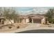 Aerial view of a single-story home, featuring desert landscaping, a two-car garage, and a stone-accented facade at 1712 W Aloe Vera Dr, Phoenix, AZ 85085