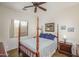 Cozy bedroom with a four-poster bed, neutral decor, and ample natural light at 1712 W Aloe Vera Dr, Phoenix, AZ 85085