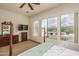 Bedroom with a window view of a pool and comfortable furniture at 1712 W Aloe Vera Dr, Phoenix, AZ 85085