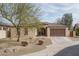 Charming single-story home with desert landscaping, a two-car garage, and a stone-accented entryway at 1712 W Aloe Vera Dr, Phoenix, AZ 85085