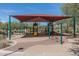 Community playground with swings, slides, climbing structures, and a shaded area to protect from the sun at 1712 W Aloe Vera Dr, Phoenix, AZ 85085