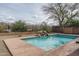 Inviting backyard pool featuring a rock waterfall feature and privacy fence at 1712 W Aloe Vera Dr, Phoenix, AZ 85085