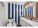 Nautical themed bathroom with stylish blue and white striped walls and a vessel sink at 1715 Leisure World --, Mesa, AZ 85206