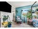 Stylish bedroom featuring decorative plants, floral chair, and a window with natural light at 1715 Leisure World --, Mesa, AZ 85206