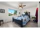 Bright bedroom features a ceiling fan, neutral paint and a window overlooking the neighborhood at 1715 Leisure World --, Mesa, AZ 85206