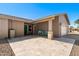 Inviting front patio features travertine tile, desert rock and quaint blue chairs and table at 1715 Leisure World --, Mesa, AZ 85206