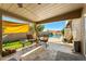 Cozy covered patio with a seating area provides an ideal spot for outdoor relaxation overlooking the pool at 1715 Leisure World --, Mesa, AZ 85206