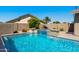 Backyard features a refreshing pool and spa with decorative waterfalls surrounded by patio and privacy fencing at 1715 Leisure World --, Mesa, AZ 85206