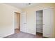 Bedroom featuring carpet flooring, closet, and a door leading to a hallway or other rooms at 17828 N 50Th St, Scottsdale, AZ 85254